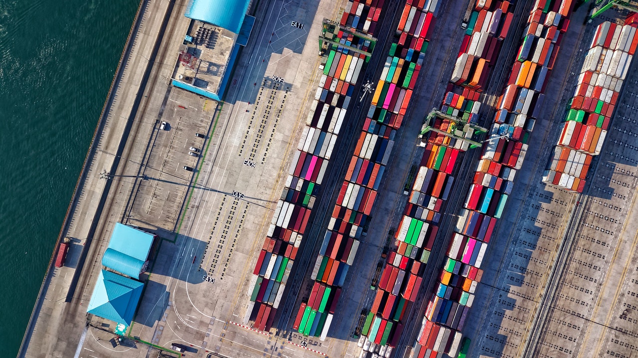 A large number of cargo containers are parked in the lot.