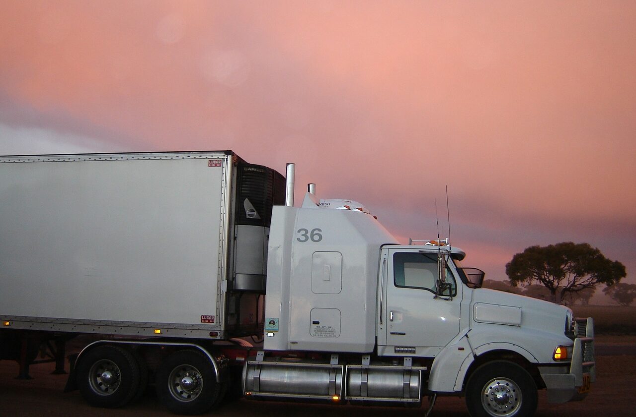 A white truck is parked on the side of the road.